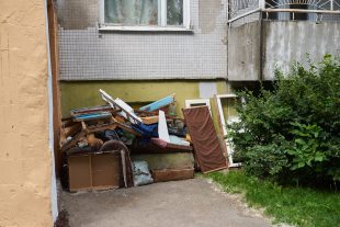 a-large-pile-of-rubbish-under-the-windows-of-a-house
