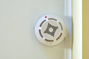 Smoke detector device on ceiling. Close-up view
