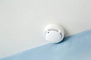 white smoke detector on ceiling